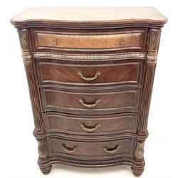 Kevin Charles American walnut serpentine chest, five graduating drawers, half turned fluted column carving, turned supports 