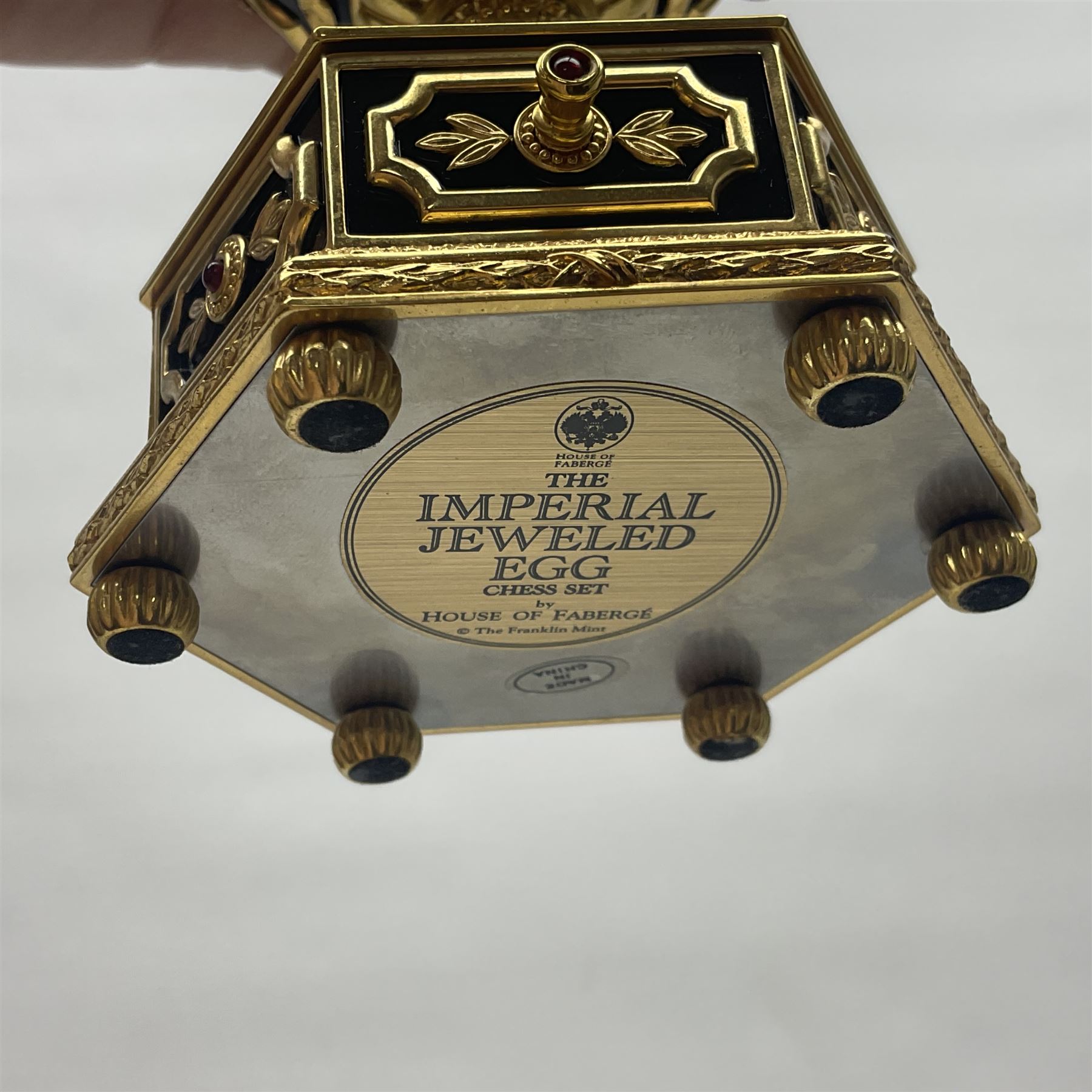 Franklin Mint House of Faberge; The Imperial Jeweled Egg Chess set, the egg opening to reveal a chess board, with a draw to the hexagonal base holding the miniature chess pieces, H23cm 