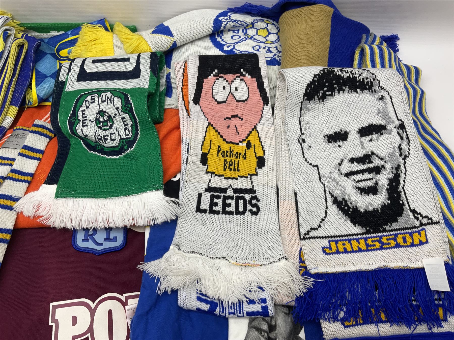Collection of Leeds United scarves, hats and t-shirts, together with a Washington Redskins NFL sweatshirt and an Australian rugby league shirt