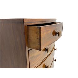 Early 19th century mahogany bow front chest, fitted with two short and three long drawers, turned feet