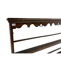 20th century oak wall hanging plate rack, shaped fretwork frieze over three tiers