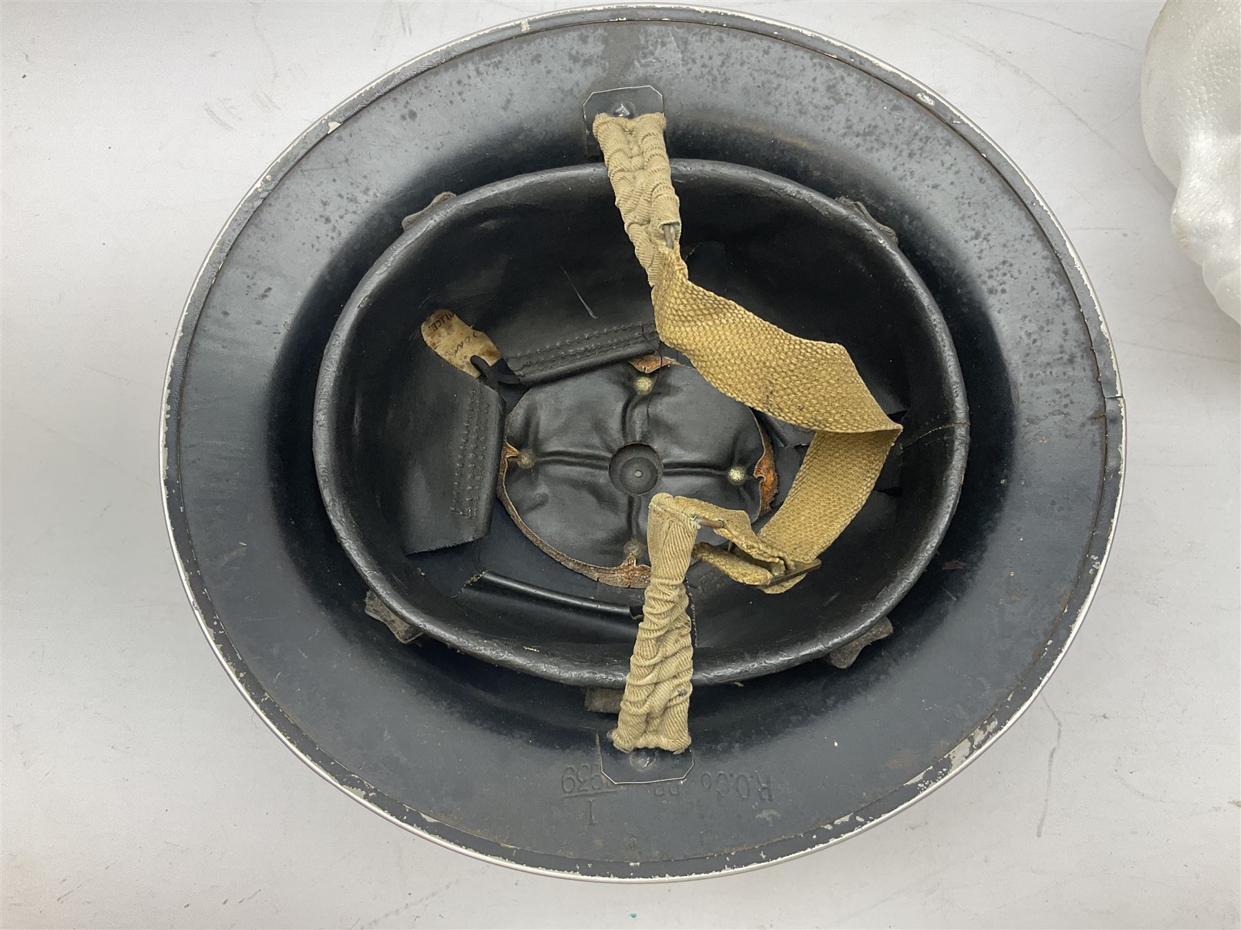WW2 Home Front 'Police' black painted steel helmet with original liner and webbing chin strap, impressed R.O. Co. 1/1939; and re-painted shell only for WW2 Wardens steel helmet impressed AMC II 1941 C676 (2)