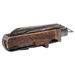 19th century coachman's folding pocket knife, the steel frame engraved with chevrons and tendrils, with antler grip scales, including set with a coachman`s key, leather punch, corkscrew, hoofpick, knife blades etc