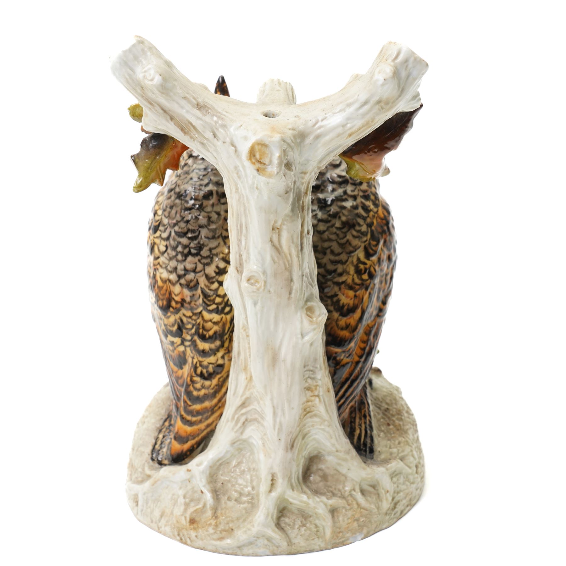 Continental figural group of two owls, possibly by Ernst Bohne & Söhne, modelled in a naturalistic setting, H25cm; together with a model delft charger (2)