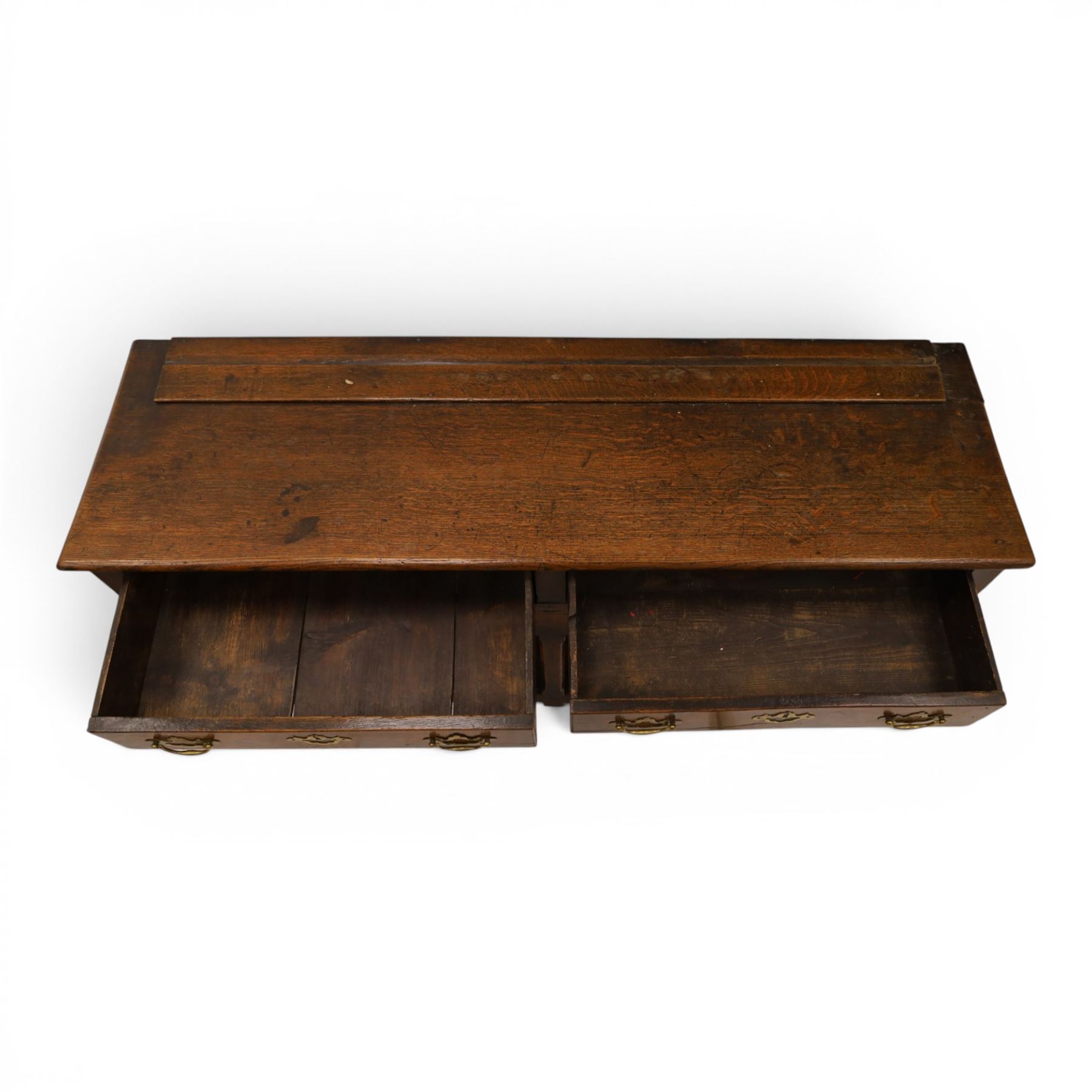 George III oak dresser base, rectangular top with moulded edge, fitted with two drawers over shaped spandrels, raised on square chamfered supports united by undertier, on stile feet