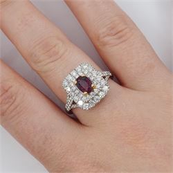 Platinum ruby diamond cluster ring, single oval cut ruby  in a four claw 18ct rose gold setting of approx 1.02 carat, surrounded by two rows of round brilliant cut diamonds and split diamond set shoulders, London 2017, total diamond weight approx 0.76 carat, with Alan Poultney Gems report