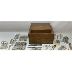 An oak canteen case with recessed twin drop carry handles, the hinged cover opening to reveal a canteen interior, above two pull our drawers, H25.5cm, together with a further smaller canteen case, (both vacant), and two part canteens of Community plate cutlery. 