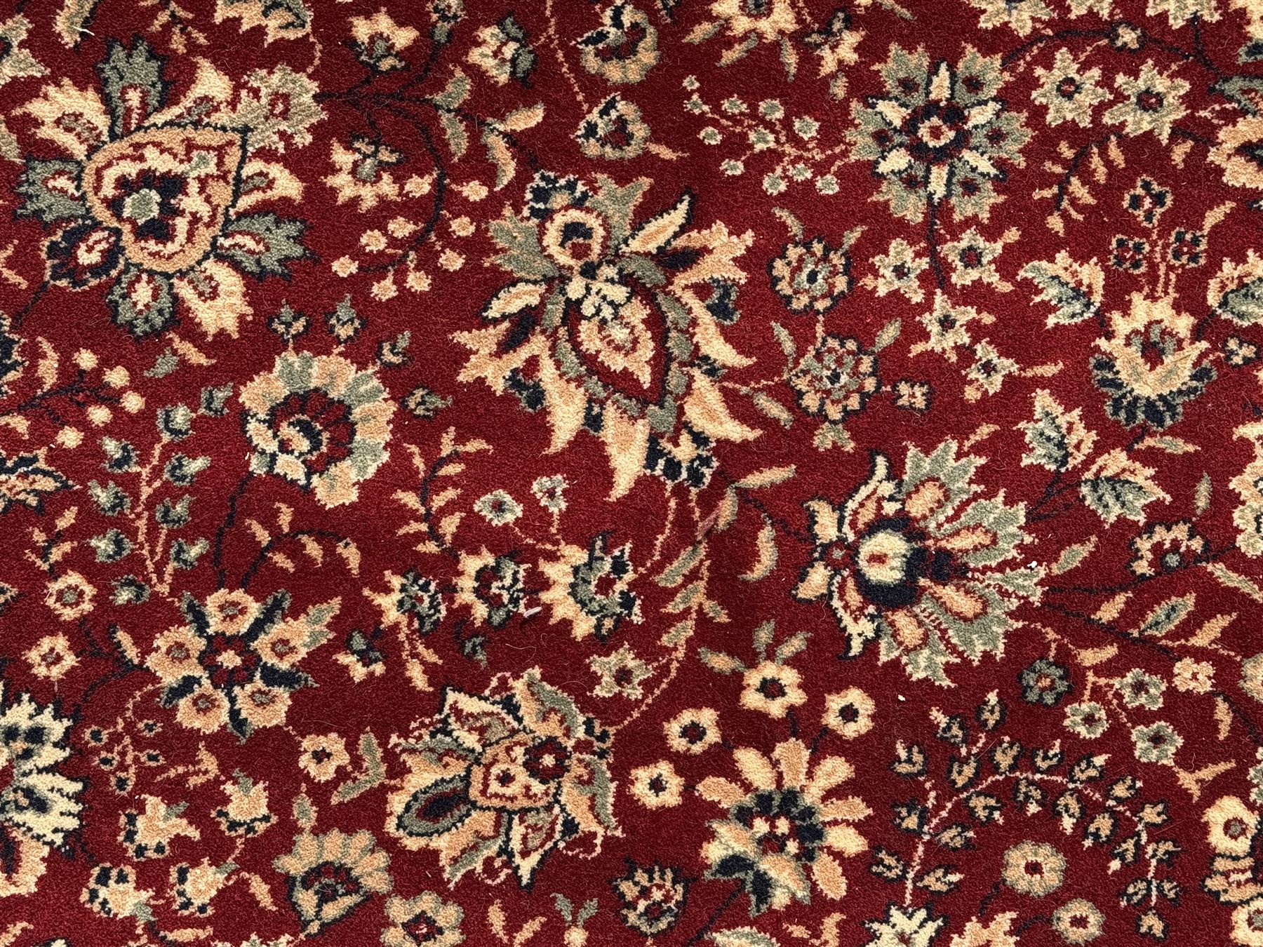 Royal Kashmir worsted wool modern Persian design area rug, with crimson field and stylised rosette patterning throughout, surrounded by wide multi-band border incorporating cartouche and lotus flower motifs