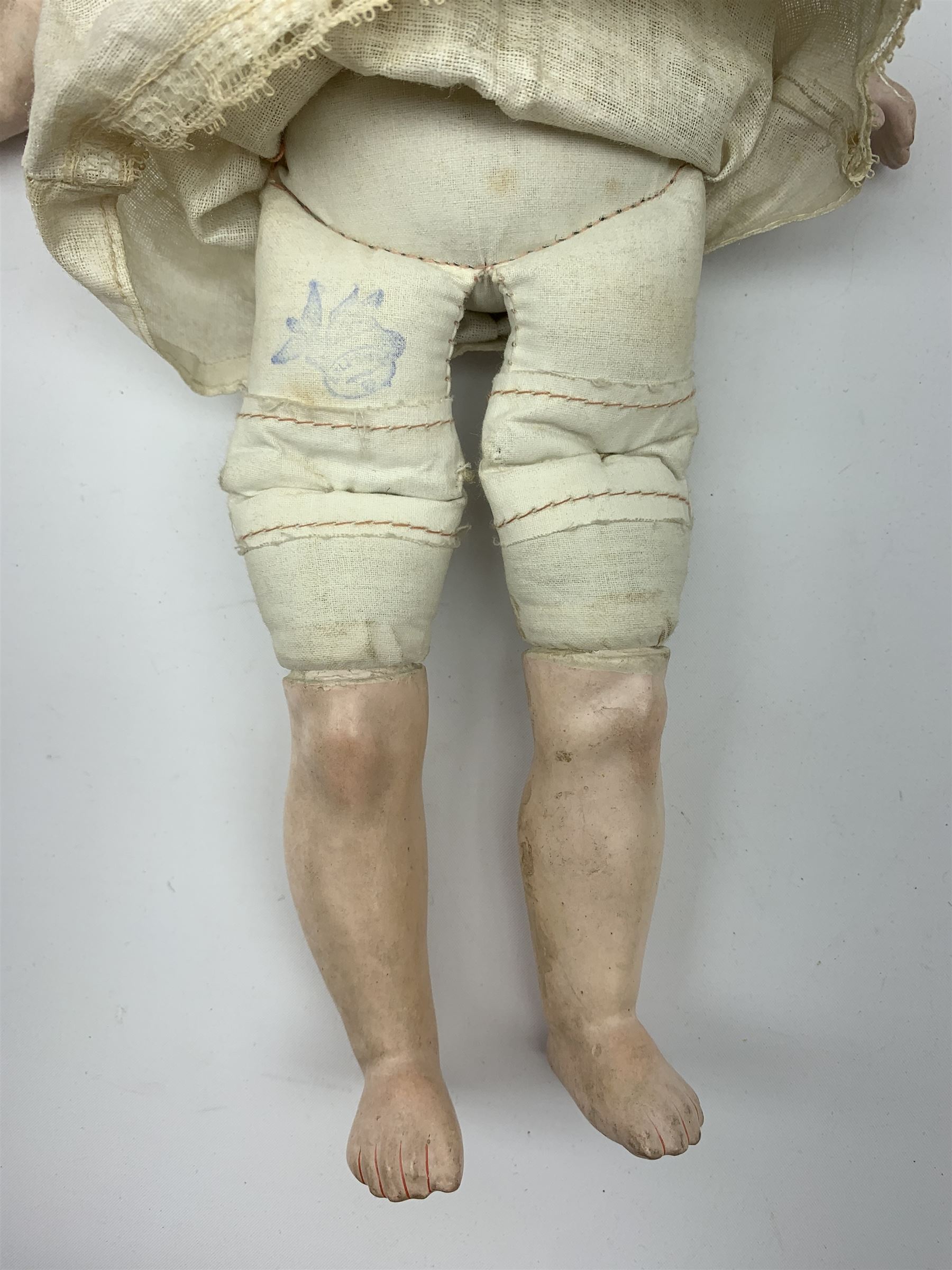 Early 20th century Cuno and Otto Dressel wax shoulder head doll with applied hair and fixed glass eyes, soft body with jointed composition lower limbs, maker's stamp to right thigh, clothing and box H38cm in original box