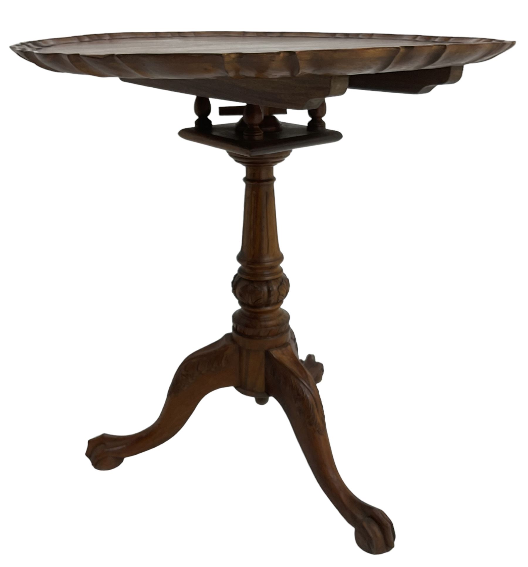 Georgian design hardwood tripod table, moulded pie-crust tilt-top, turned and fluted column carved with foliage, on three acanthus leaf carved splayed supports with ball and claw feet