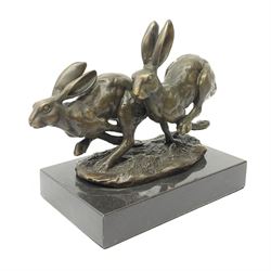 A bronze figure group, modelled as two hares in chase, upon a naturalistic base signed Nick and with foundry mark, raised upon a rectangular marble base, overall H12cm. 