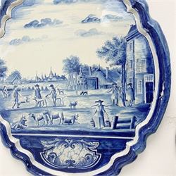 A late 19th century/early 20th century Dutch Deltware blue and white wall plaque, of oval form decorated with a pastoral scene of figures and cattle, H60cm W52cm.