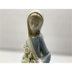 Four Lladro figures, comprising Afternoon Promenade no 7636, Nostalgia no 5071, both with original boxes, Girl with Lilies no 4972 and Madonna no 4534, largest example H27cm
