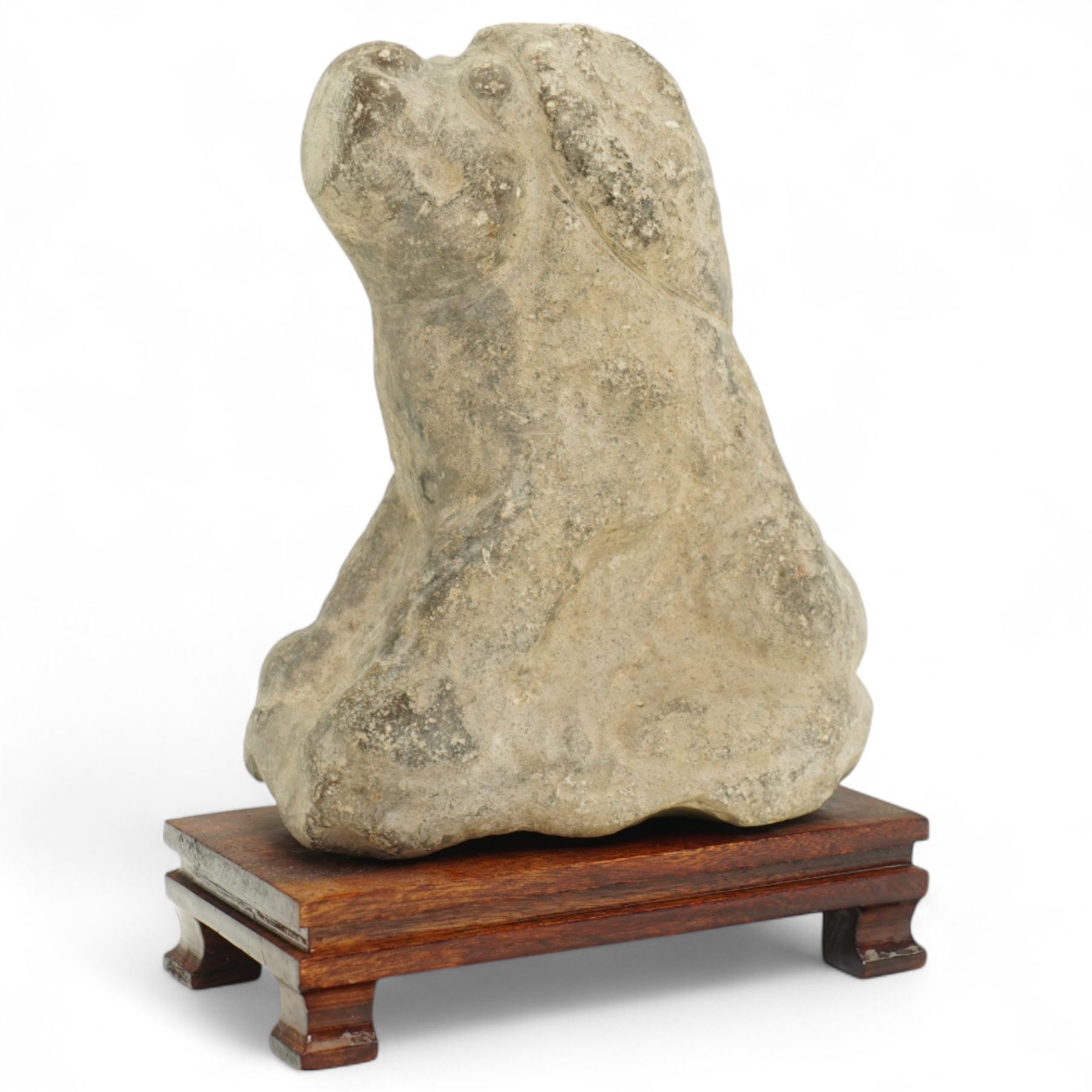 Chinese Western Han Dynasty (206BC–24AD) carved seated stone dog, stylized figure with upright ears and upraised squared snout, grey stone with weathered surface and tool marks visible to underside W13cm H16.5cm