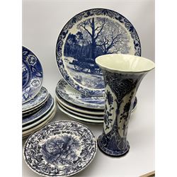 A large collection of modern transfer printed Delft ware, to include large baluster vase, H42cm, two jars and covers, largest H40cm, pair of tapering cylindrical vases, H31cm, and a number of plates of various size and design. 