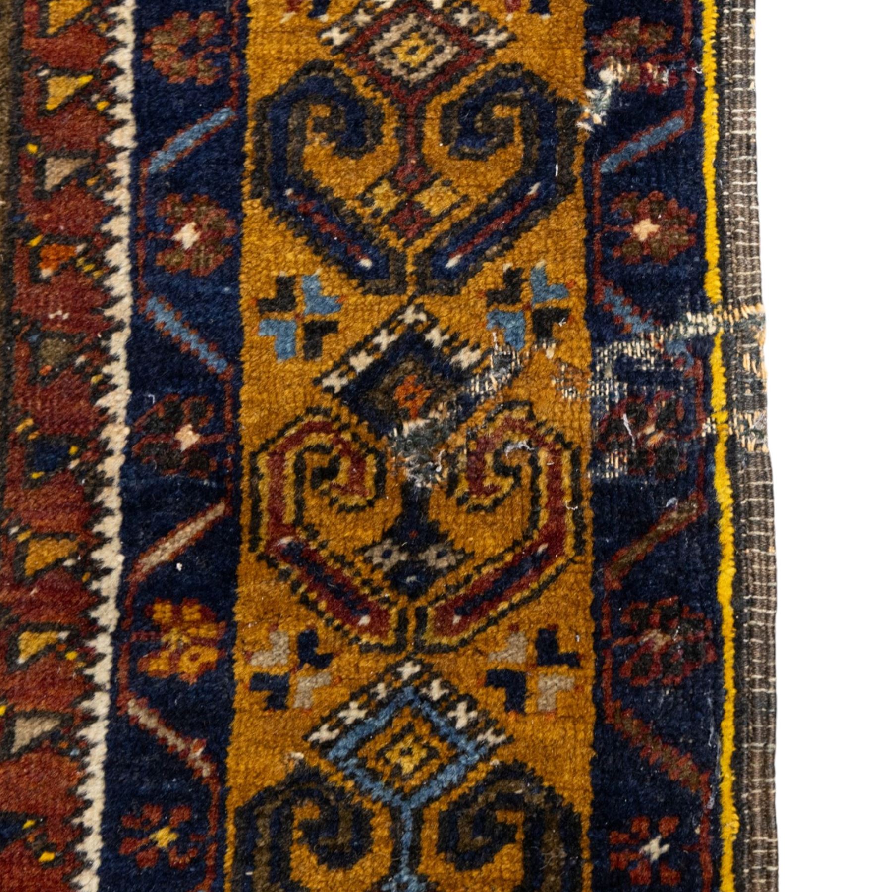Turkish Anatolian wool rug, central stepped medallion on dark blue lozenge field, red spandrels with stylised hooked motifs, ochre border decorated with repeating geometric motifs and guard stripes