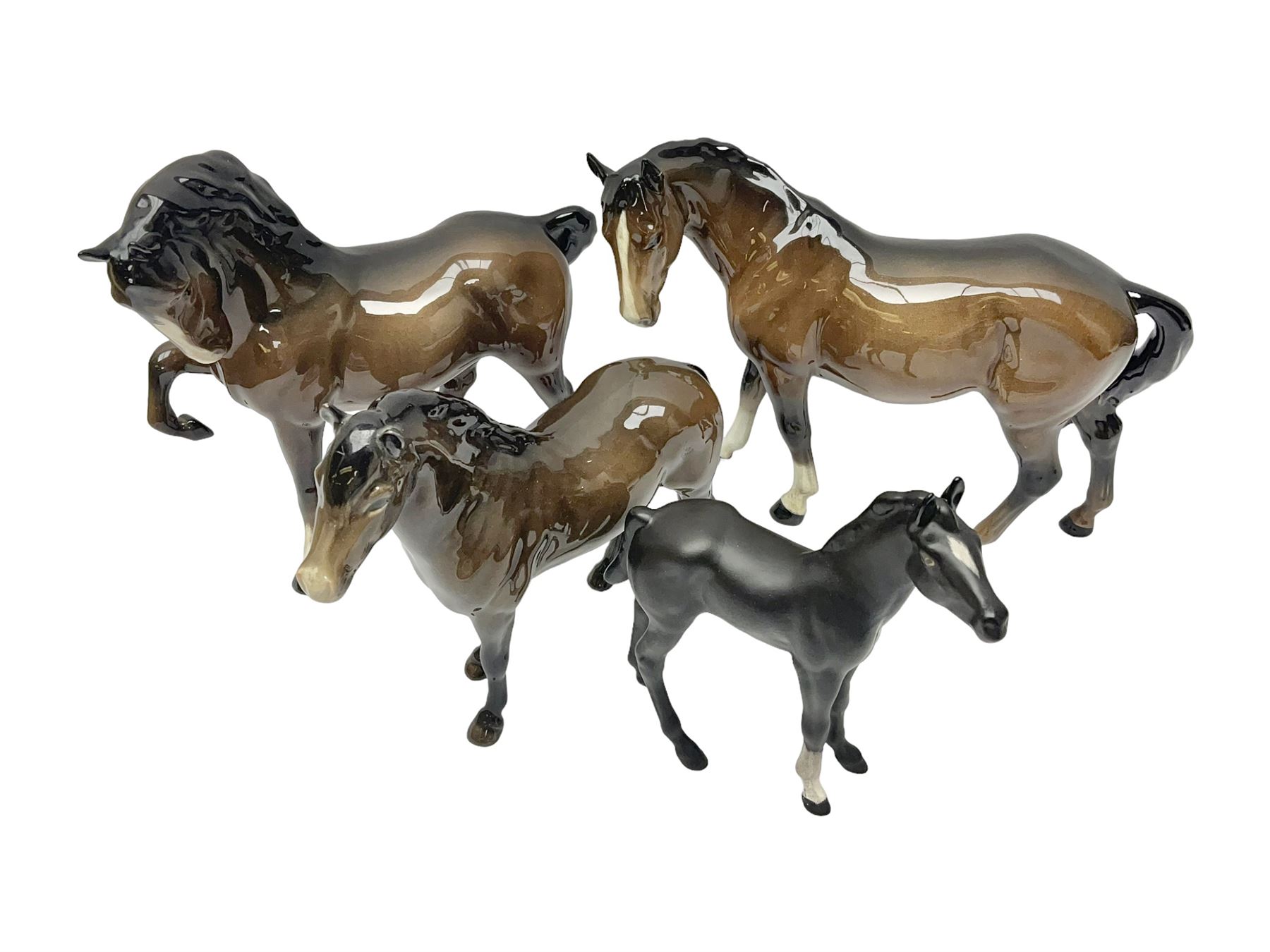 Four Beswick horses, including Exmoor no 1645, Black Beauty foal and two others 