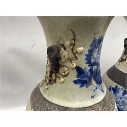 Pair of Chinese blue and white crackle glazed vases decorated with birds in blossoming branches with oxidised trim, H46cm