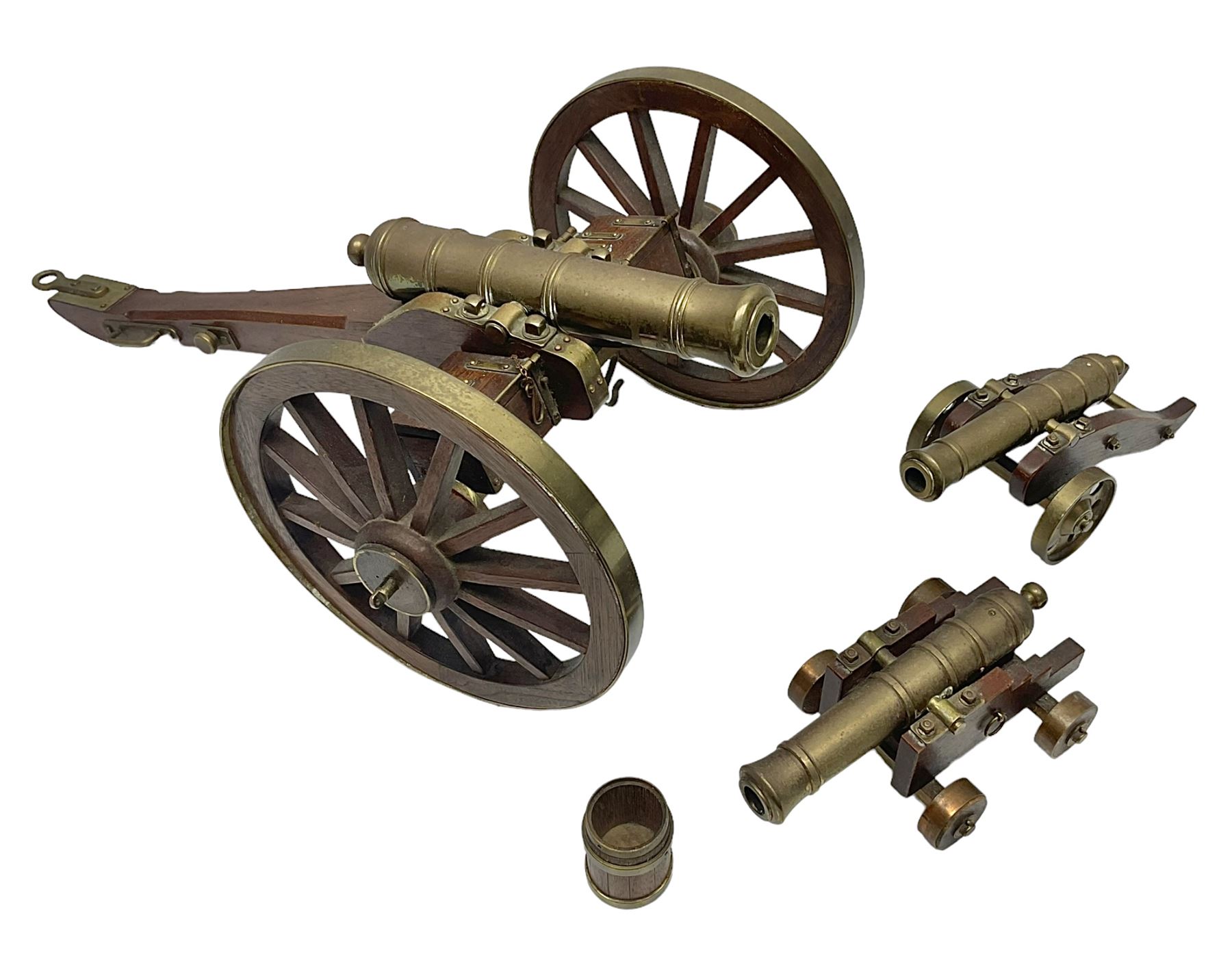 Large model brass cannon, upon wooden base, together with two similar smaller cannons, largest L48cm