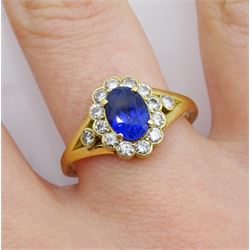 18ct gold oval cut sapphire and round brilliant cut diamond cluster ring, with diamond set split shoulders, hallmarked, sapphire approx 1.15 carat