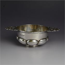 Edwardian silver quaich, of part fluted circular form with twin pierced foliate handles, h...