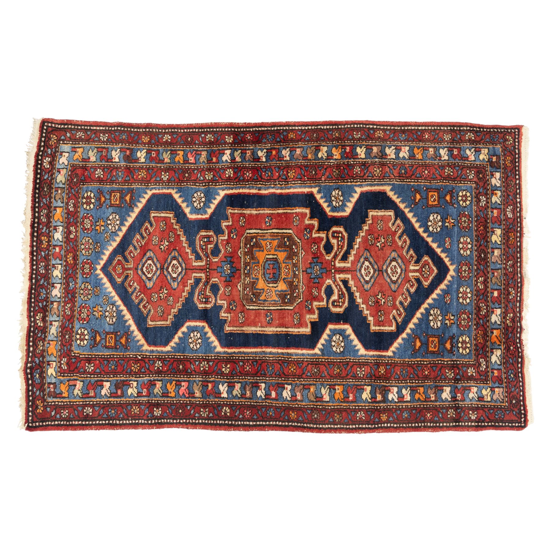 Persian Qashqai rug, wool on cotton foundation, triple stepped lozenge medallions with stylised motifs on a blue ground, within floral and geometric borders in rich red and cream
