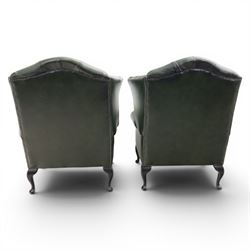Thomas Lloyd - Pair of Queen Anne design wingback armchairs upholstered in buttoned green leather, button back and scrolled arms, raised on cabriole supports. 