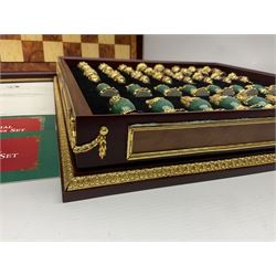 Franklin Mint House of Faberge 'The Imperial Jewelled Chess Set', to include set of chess pieces with malachite finish and a set with carnelian finish and a hardwood chess board