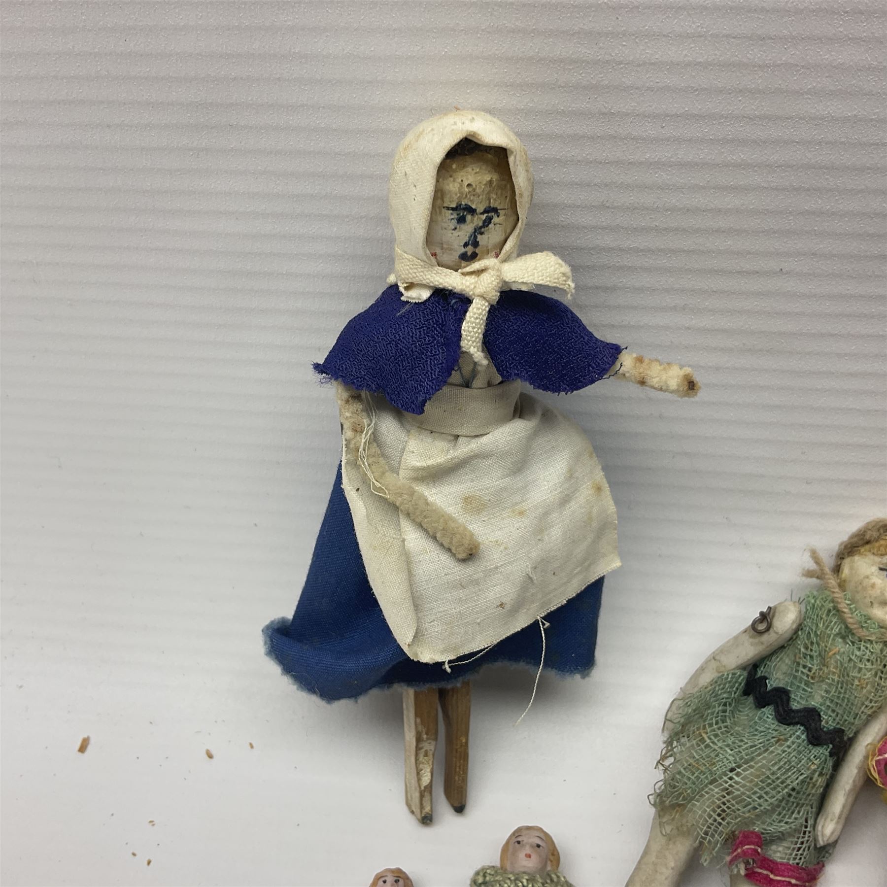 Twelve miniature bisque, bisque headed and wooden dolls to include articulated examples, tallest 12cm 