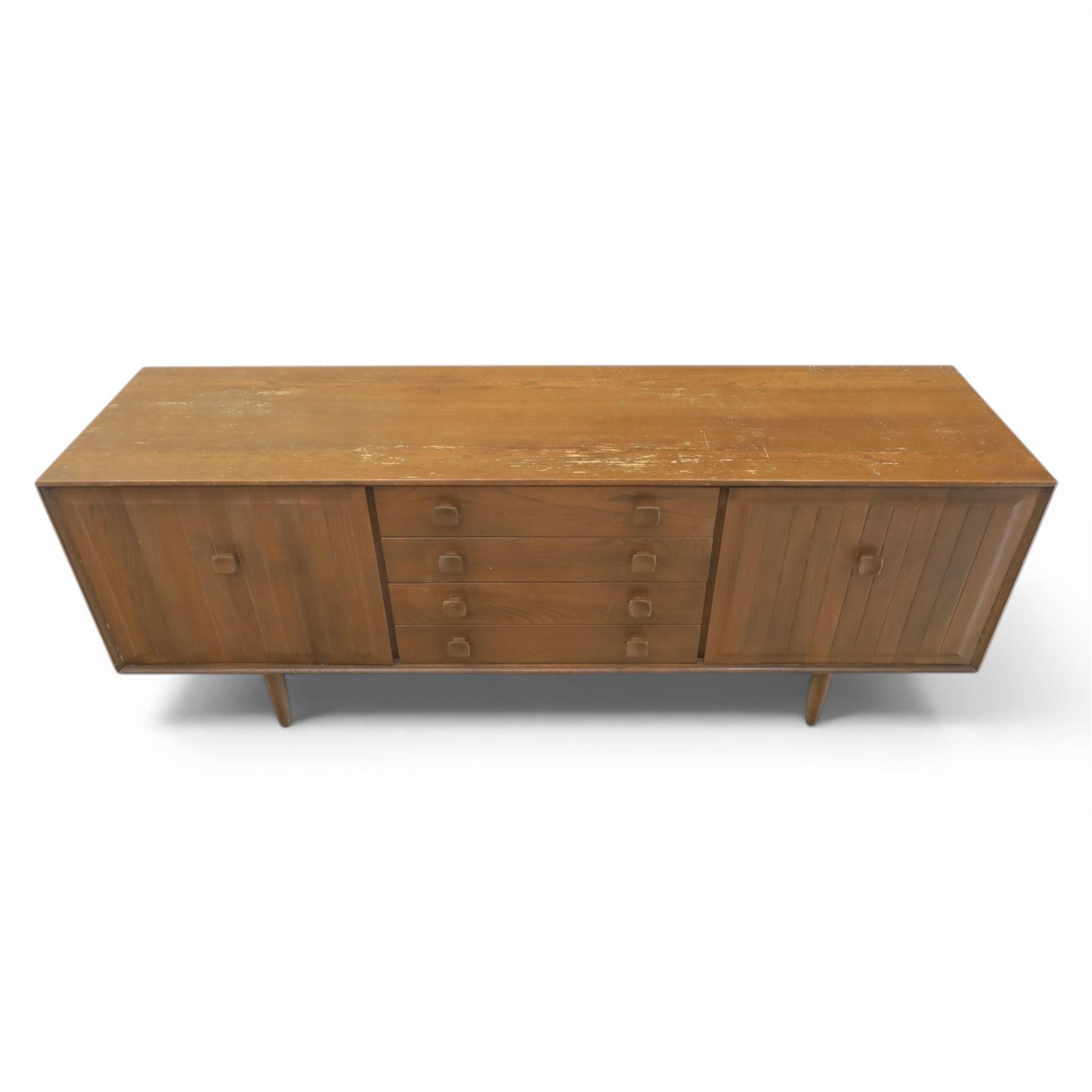 Ensign - Mid-20th century elm sideboard, with a central bank of four drawers, flanked by cupboard doors, raised on tapering supports, labelled Ensign Bristow & Townsend Ltd