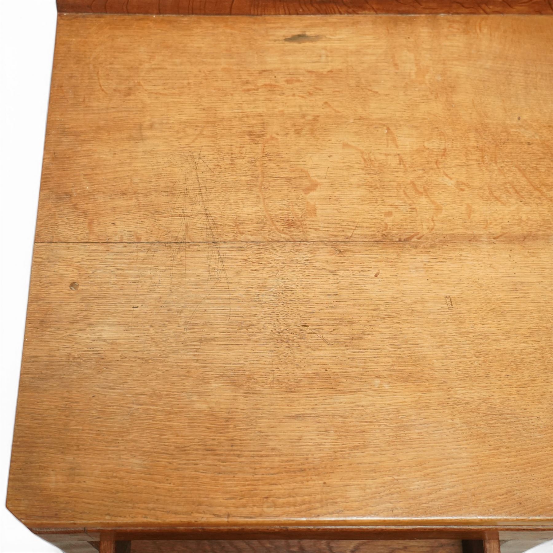 Rabbitman - oak single pedestal desk, adzed top with galleried back, with three graduating drawers with turned wooden knobs, enclosed kneehole with adzed detailing throughout the panelling and supports, with carved rabbit signature, by Peter Heap of Wetwang