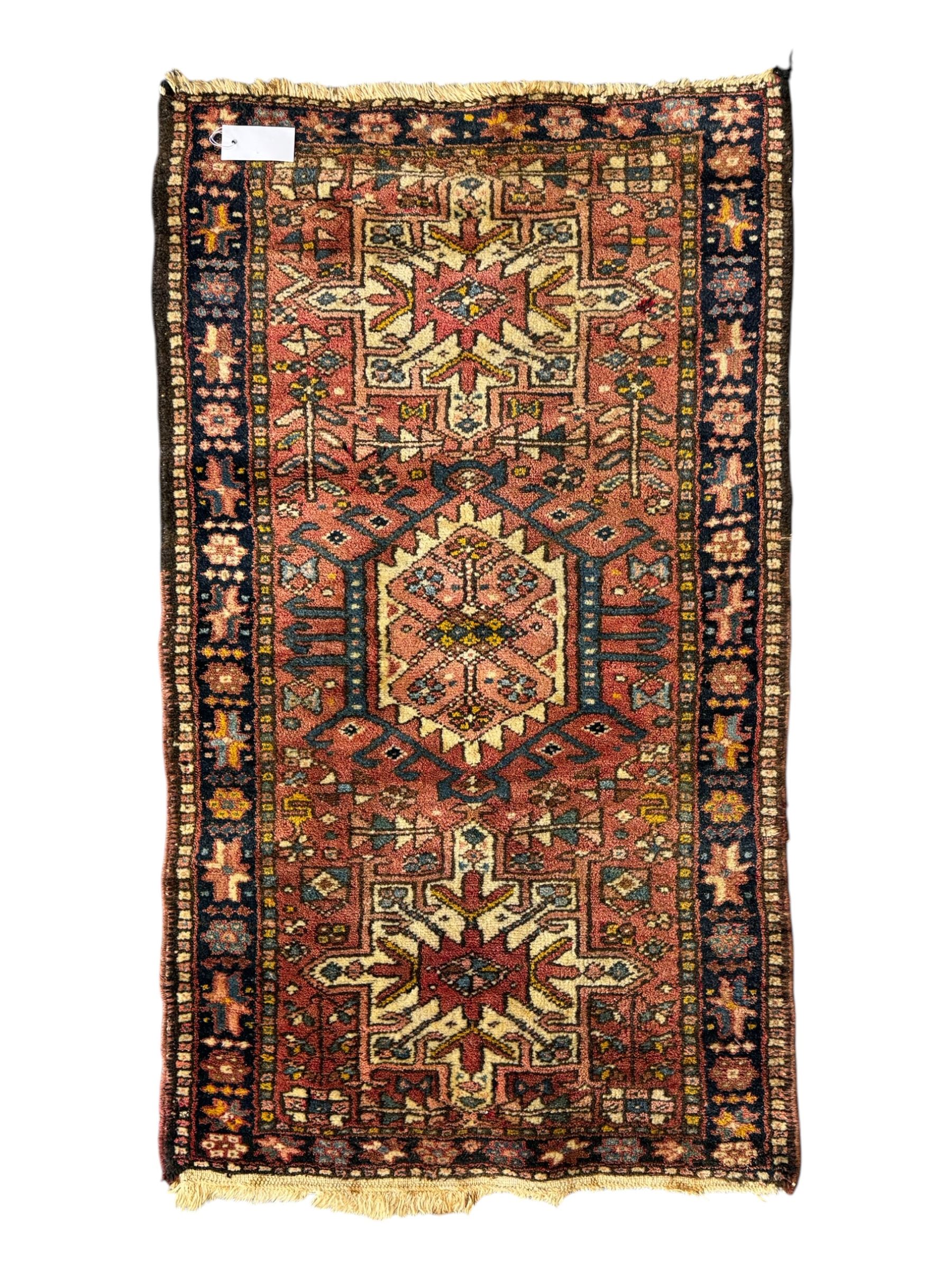 Belgian Sultan woollen ground rug, central navy field densely decorated with floral sprays and geometric patterns (192cm x 135cm); handwoven tribal terracotta ground rug (121cm x 71cm); Persian crimson ground runner, all over stylised floral and foliate motifs (266cm x 94cm)