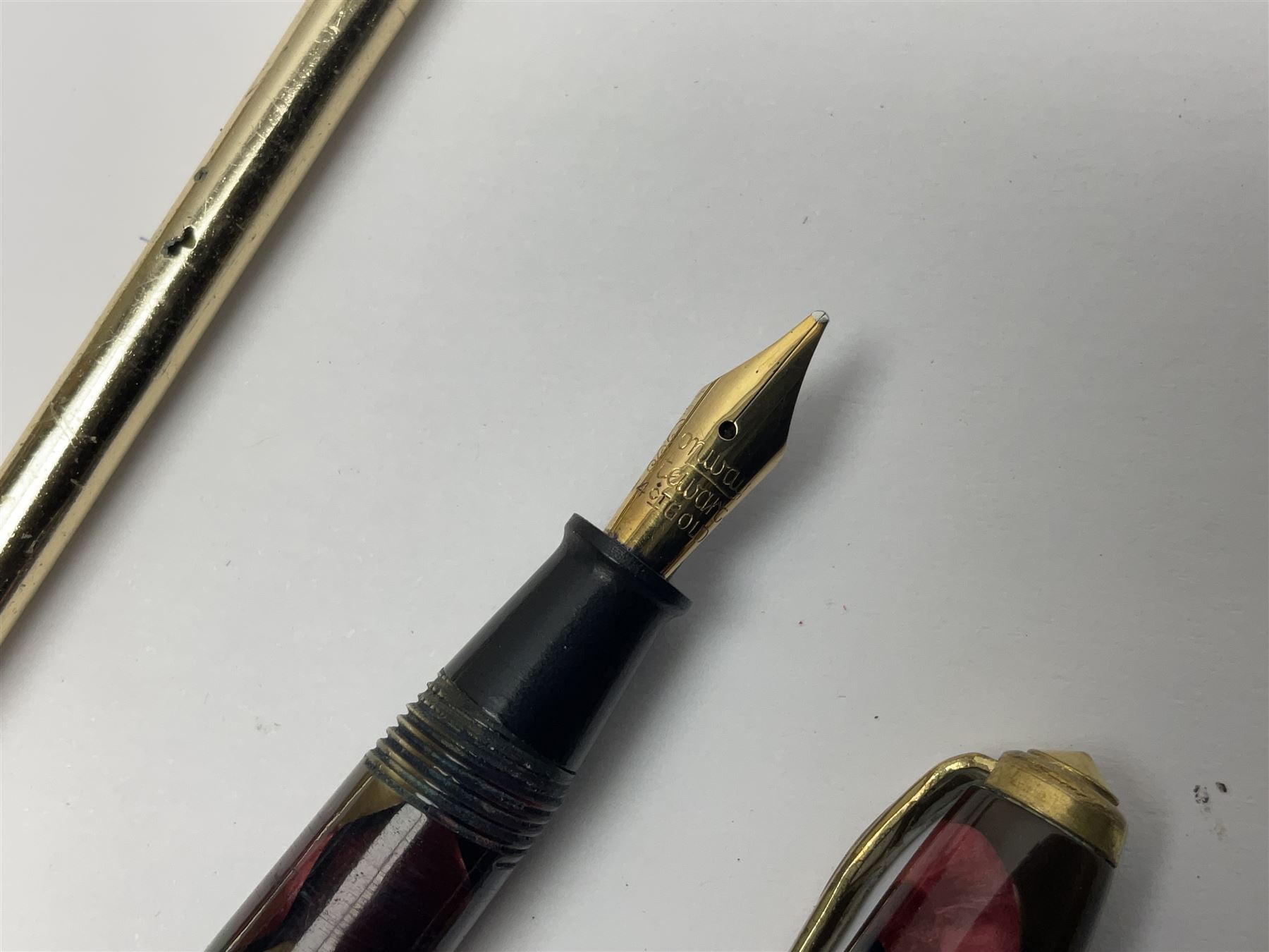 Three fountain pens, to include Conway Stewart 'Dinkie 550' and 'Conway 57' and a Parker 'Slimfold', all with 14ct gold nibs, together two roller ball pens, including a Parker example and a Swarovski Crystal paperweight