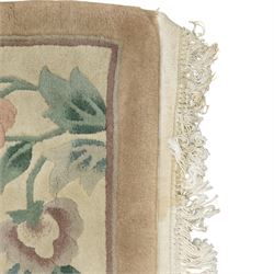 Chinese wool rug, beige ground decorated with peonies, flowering branches and butterflies, centred by a shou symbol within key pattern surround, cream border with floral sprays and double happiness motifs, cotton fringe ends