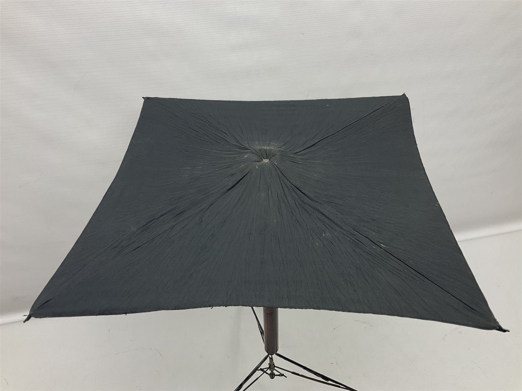 Victorian magician's cane, the mahogany walking stick twisting apart to reveal an internal mechanism, opening to tripod and black silk fold out magician's table, with horn handle and silver mount, hallmarked Birmingham 1891