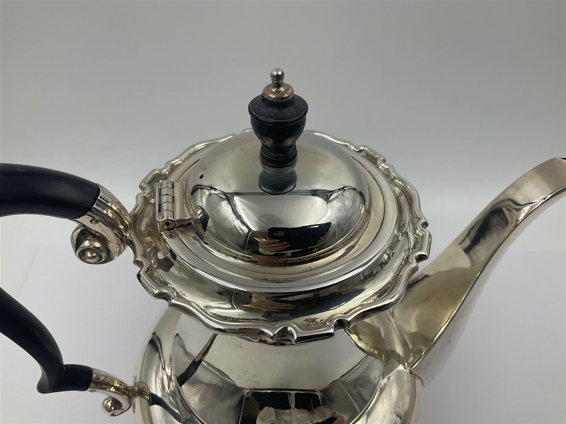 1920s five-piece silver tea service, comprising teapot, coffee pot, hot water pot, twin handled open sucrier and milk jug, each of squat circular form with shaped rim, the teapot, coffee pot and hot water pot each with ebonised handle and finial, the sucrier and milk jug with acanthus capped scroll handles, all upon circular foot, hallmarked R F Mosley & Co, Sheffield 1926 & 1927, tallest H24cm