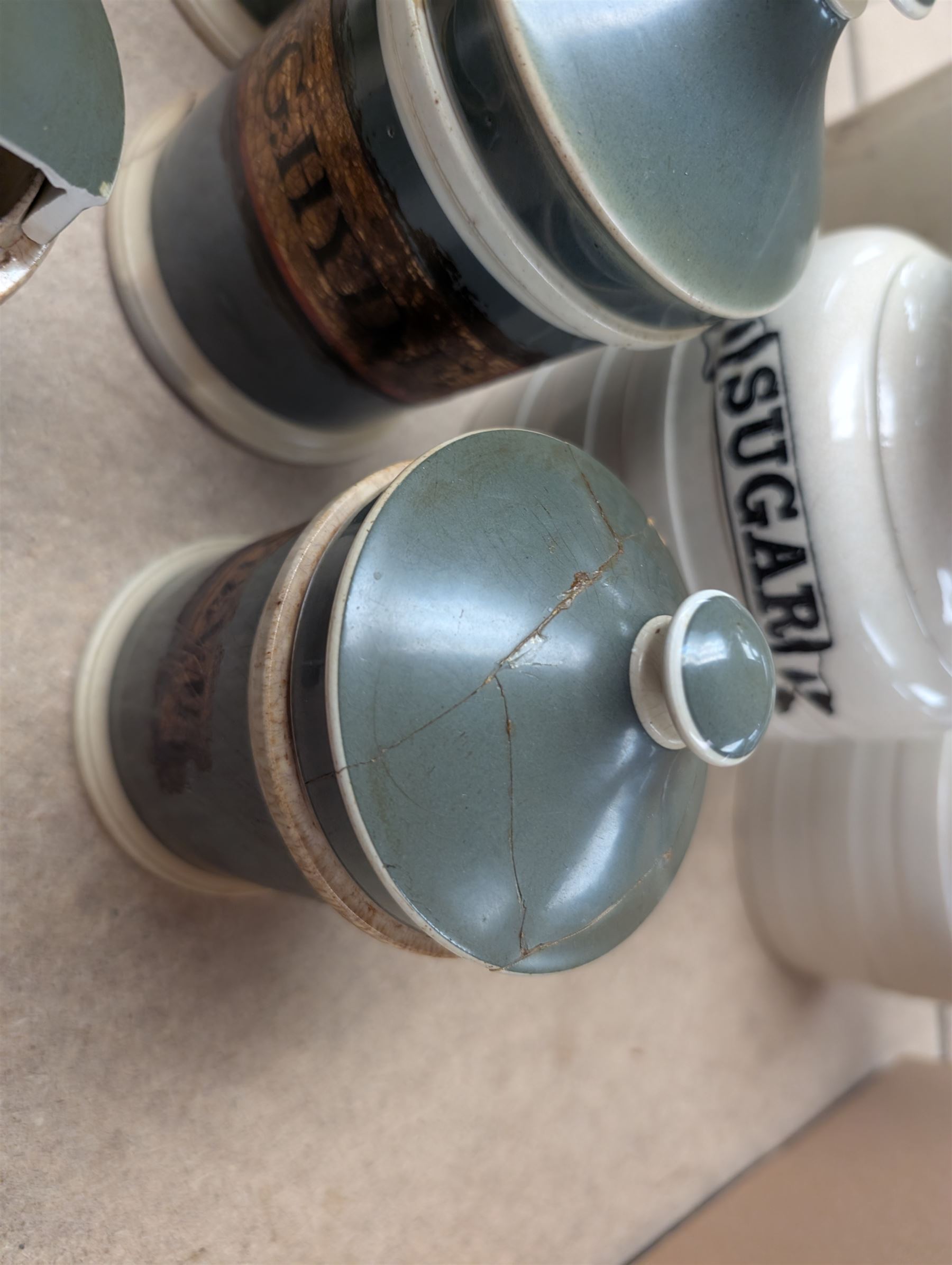 19th century sage green apothecary jars with gilt labels, four white ceramic kitchen jars and a stoneware flaggon marked Wheat Wine