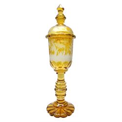 Large Bohemian amber flashed glass goblet and cover, the faceted bowl and domed cover engraved with stags in a woodland landscape, upon a knopped and oval faceted baluster stem, and circular lobed base, the cover with conforming knopped and faceted finial, overall H54cm