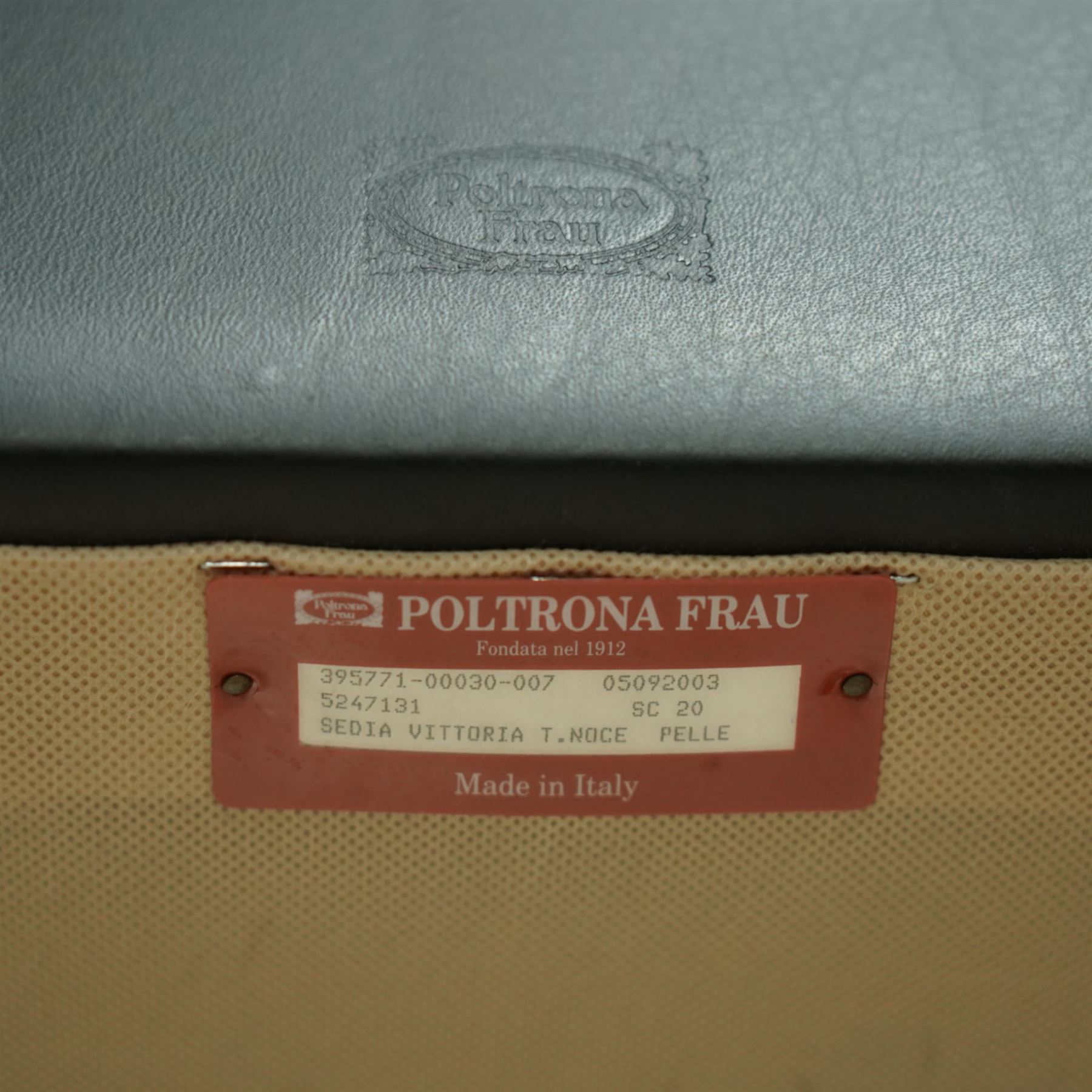 Poltrona Frau - set of eight ‘Vittoria’ dining chairs, each upholstered in black Pelle Frau leather with rolled top-cresting backs and saddle-stitched seams, raised on tapering stained beech supports