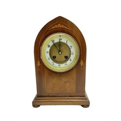 French - mahogany 8-day lancet clock c1910, with an inlaid front raised on a shallow plinth with bun feet, two part dial with a recessed gilt centre and enamel chapter, Arabic numerals, minute markers and steel hands, twin train striking movement sounding the hours and half-hours on a coiled gong, with pendulum and key