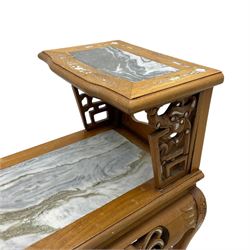 Pair of Chinese hardwood side or end tables, two moulded tiers with grey marble insets, inlaid with trailing foliate motifs in mother of pearl, with scrolling fretwork frieze rails, on cabriole supports with ball and claw feet united by plain stretchers 