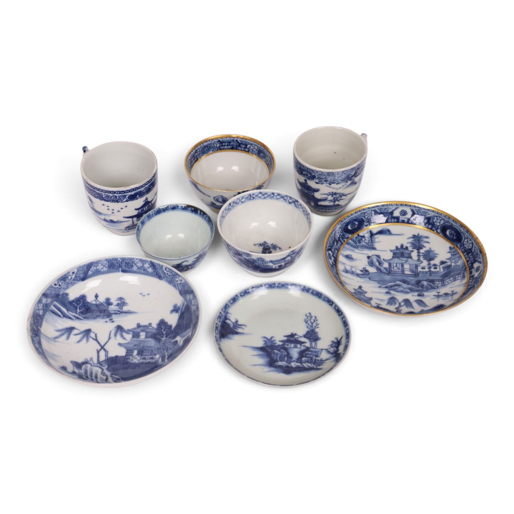 18th century Chinese blue and white ‘Nanking Cargo’ tea bowl and saucer, painted with pagoda in a landscape, with Christie's lot label No 5110, together with another tea bowl with similar decoration and gilt detail and other blue and white