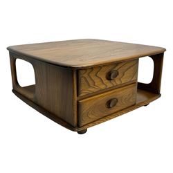 Lucian Ercolani for Ercol - elm 'Pandora's Box' coffee table, square top with rounded corners over two drawers with sculpted recessed pulls, open sides supporting undertier, on castors 