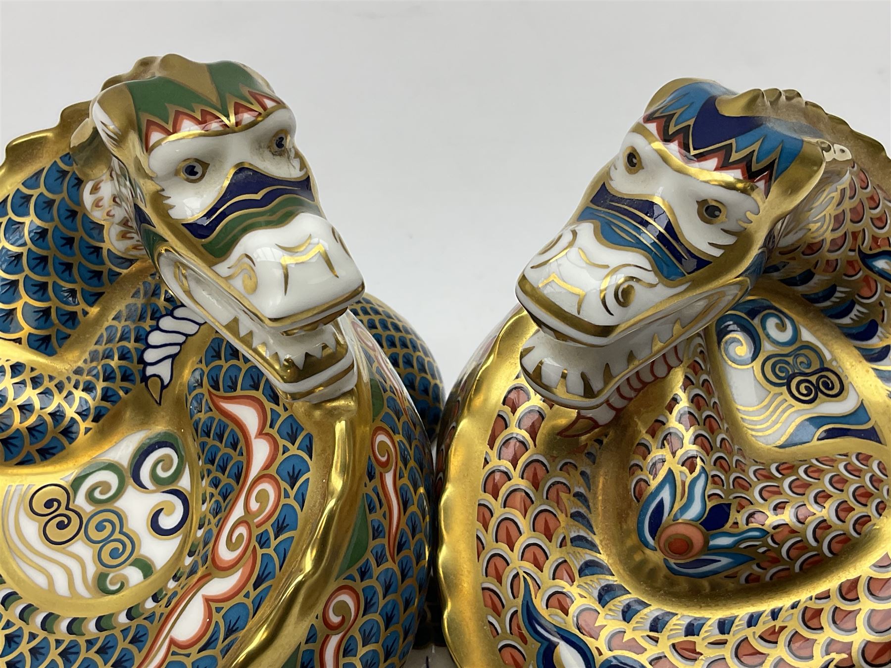Two Royal Crown Derby paperweights, Dragon of Happiness, limited edition 1227/1500 and Dragon of Good Fortune, limited edition 1227/1500, both with gold stopper, hardwood base, certificate and with printed mark beneath
