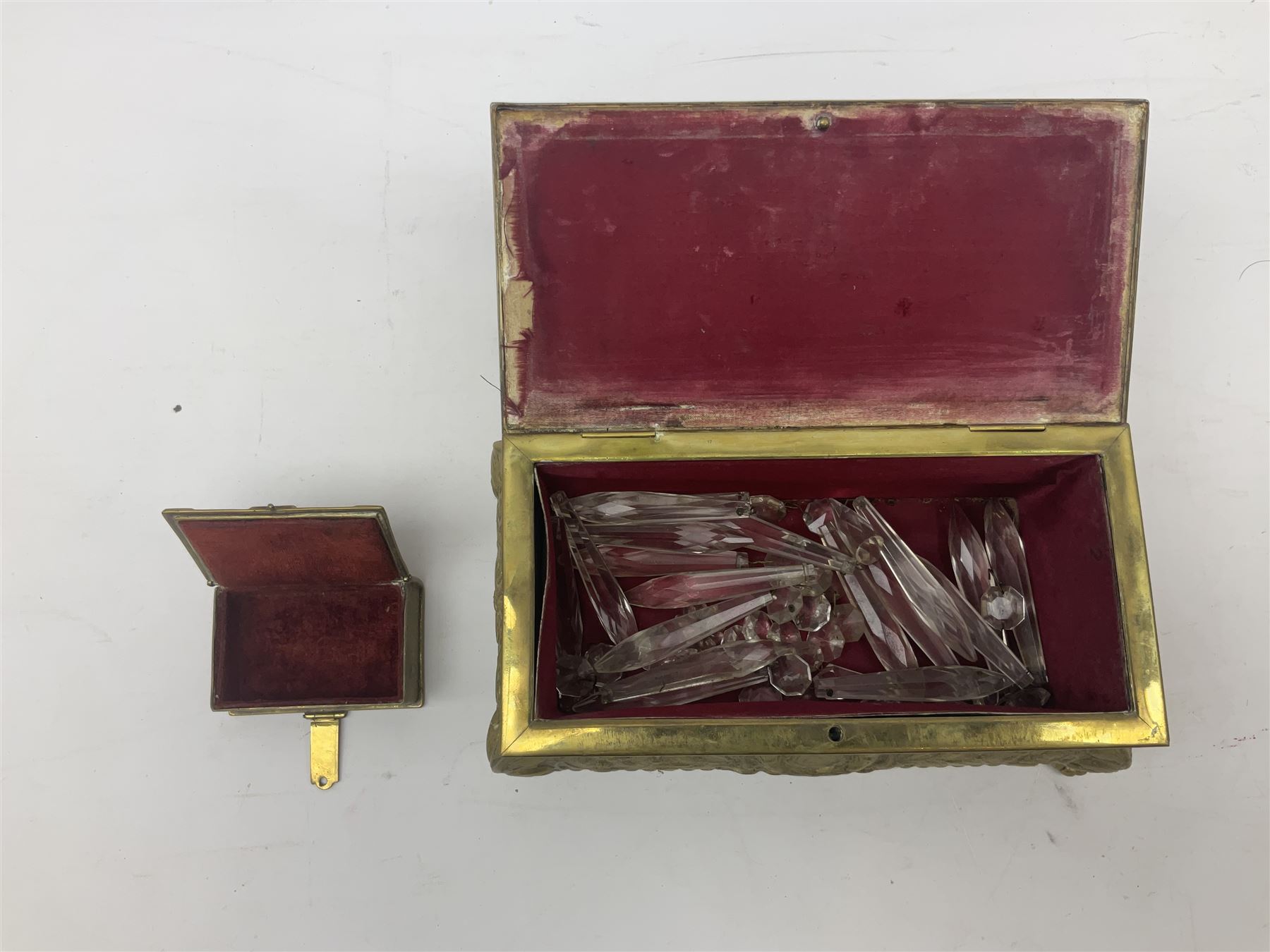 Collection of victorian and later brass desk accessories, to include a letter holder with cherub design, ink well of square form with hinged lid, brass table bell, brass casket with relief decoration, etc  