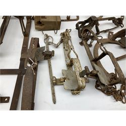 Quantity of animal traps including, gin traps, mole traps, Henri Marty wirework cage trap etc. Auctioneer's Note: These traps are sold as artefacts for ornamental purposes only as the use of some of them is illegal.