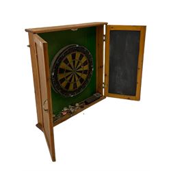Dart board in wooden cabinet