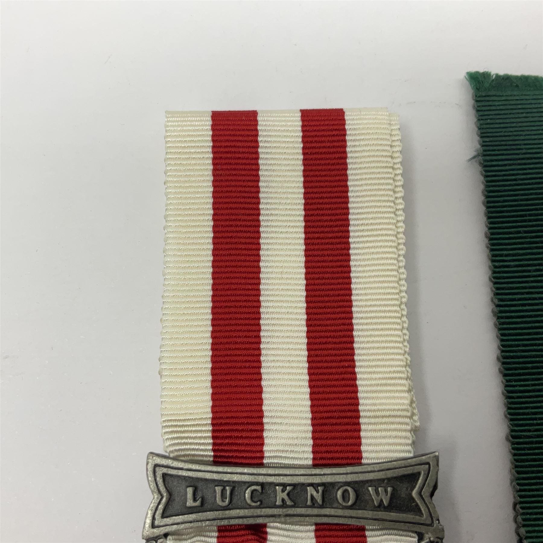Victoria Long Service in the Volunteer Force Medal awarded to 369 Bombr. W. Woodward 1st Lincs. V.A.; and reproduction Victoria India Medal with Lucknow clasp; both with ribbons (2)