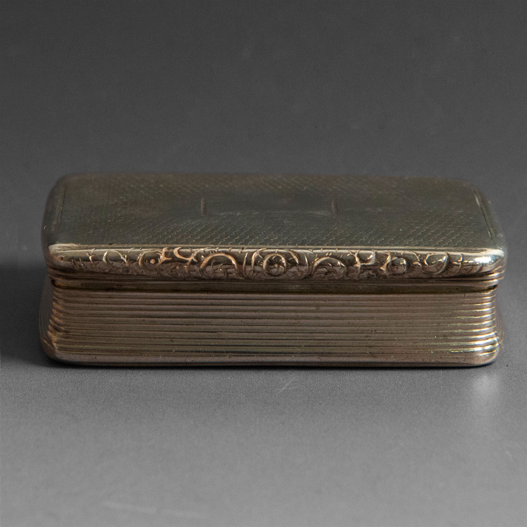 William IV silver snuff box, of rectangular form with rounded corners and embossed lip, the hinged cover with engine turned decoration and vacant cartouche, hallmarked Joseph Willmore, Birmingham 1830, H2cm, W7cm