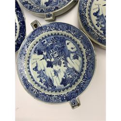 Set of seven late 18th/early 19th century Chinese export blue and white hot water plates, decorated with landscape set with pagoda, islands, bridge, and two figures within a white reserve, within spearhead and foliate borders, W28cm